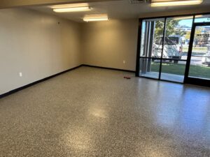 Interior of an unfurnished room with glass doors and a view outside with fresh coating by Hermetic Coatings